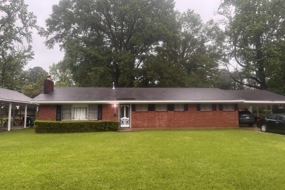 Long red brick ranch home with clean white fascia and trim after a house wash in Haughton, LA