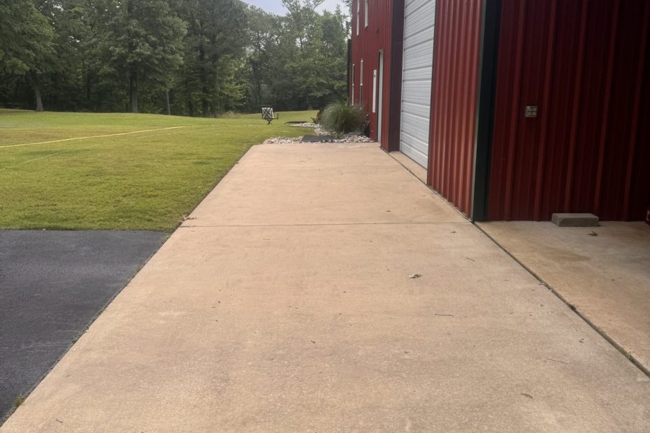 Freshly cleaned concrete apron along a red metal building in Haughton, LA