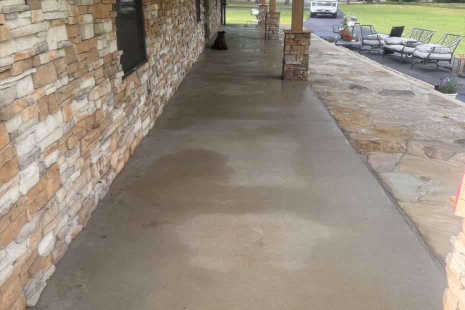 Long covered porch with wet, freshly washed concrete in Haughton, LA