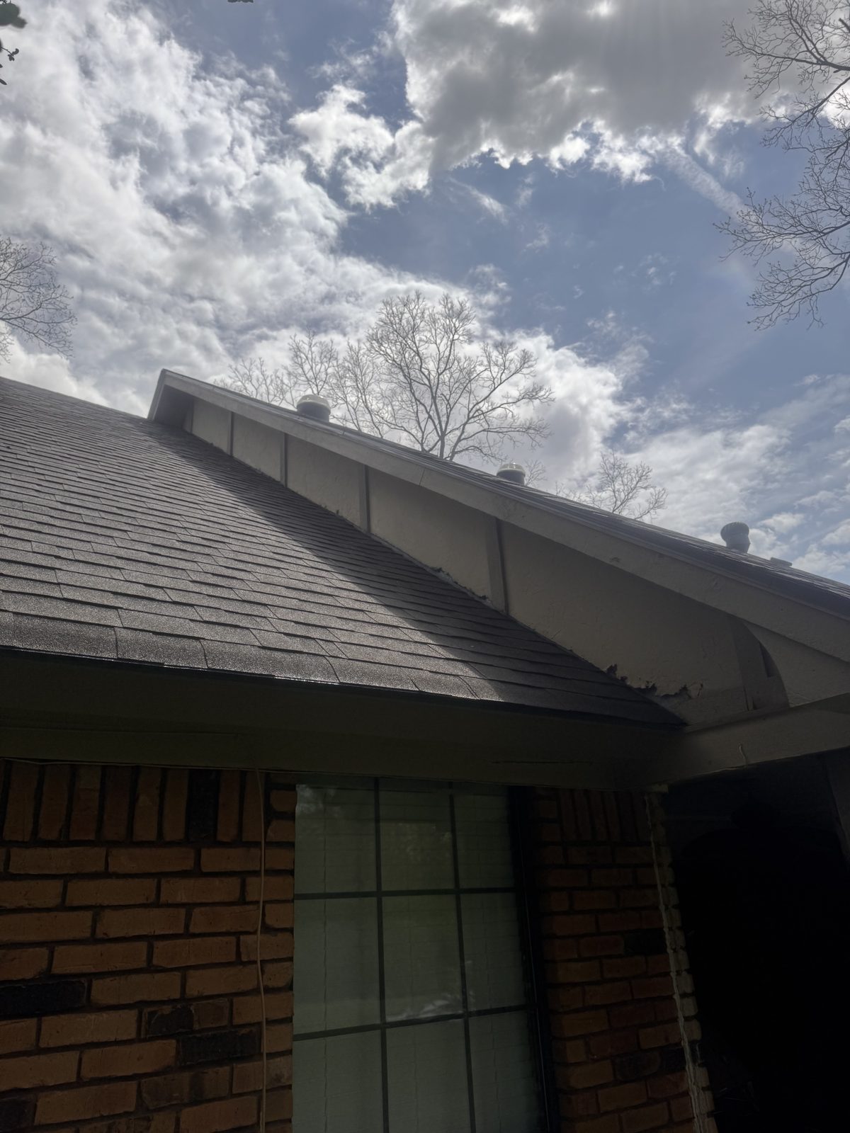 Shingle roof gable and fascia under a cloudy sky in Haughton, LA